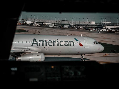 Free Commercial airplane from American Airlines positioned on airport tarmac, ready for departure or arrival. Stock Photo