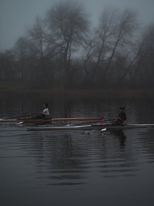 People Paddling a Boat in the Lake