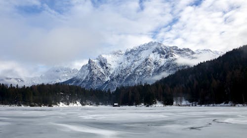 Snow Covered Mountain Under White Clouds