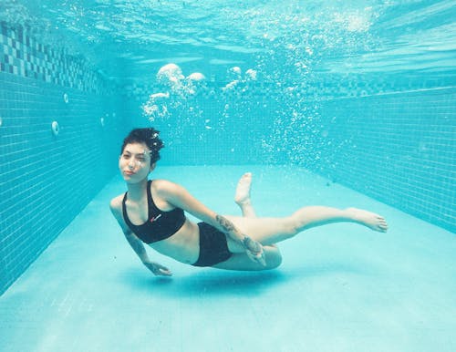 Woman in Black Bikini Lying on Underwater
