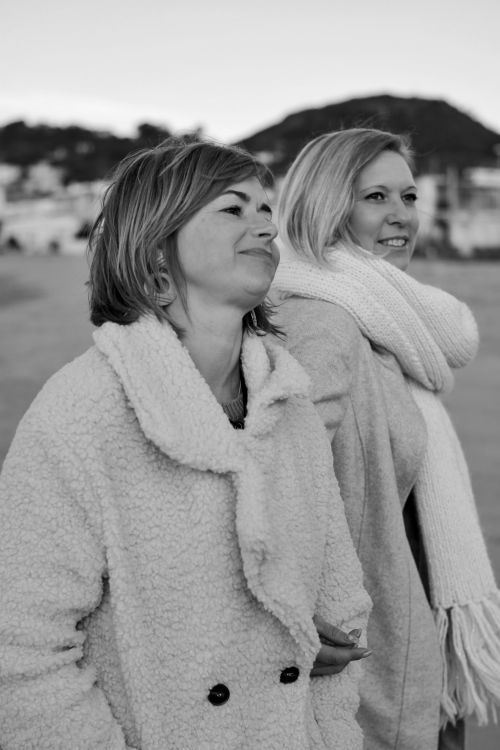 Free Two women in winter coats enjoy a peaceful outdoor setting. Black and white photo. Stock Photo
