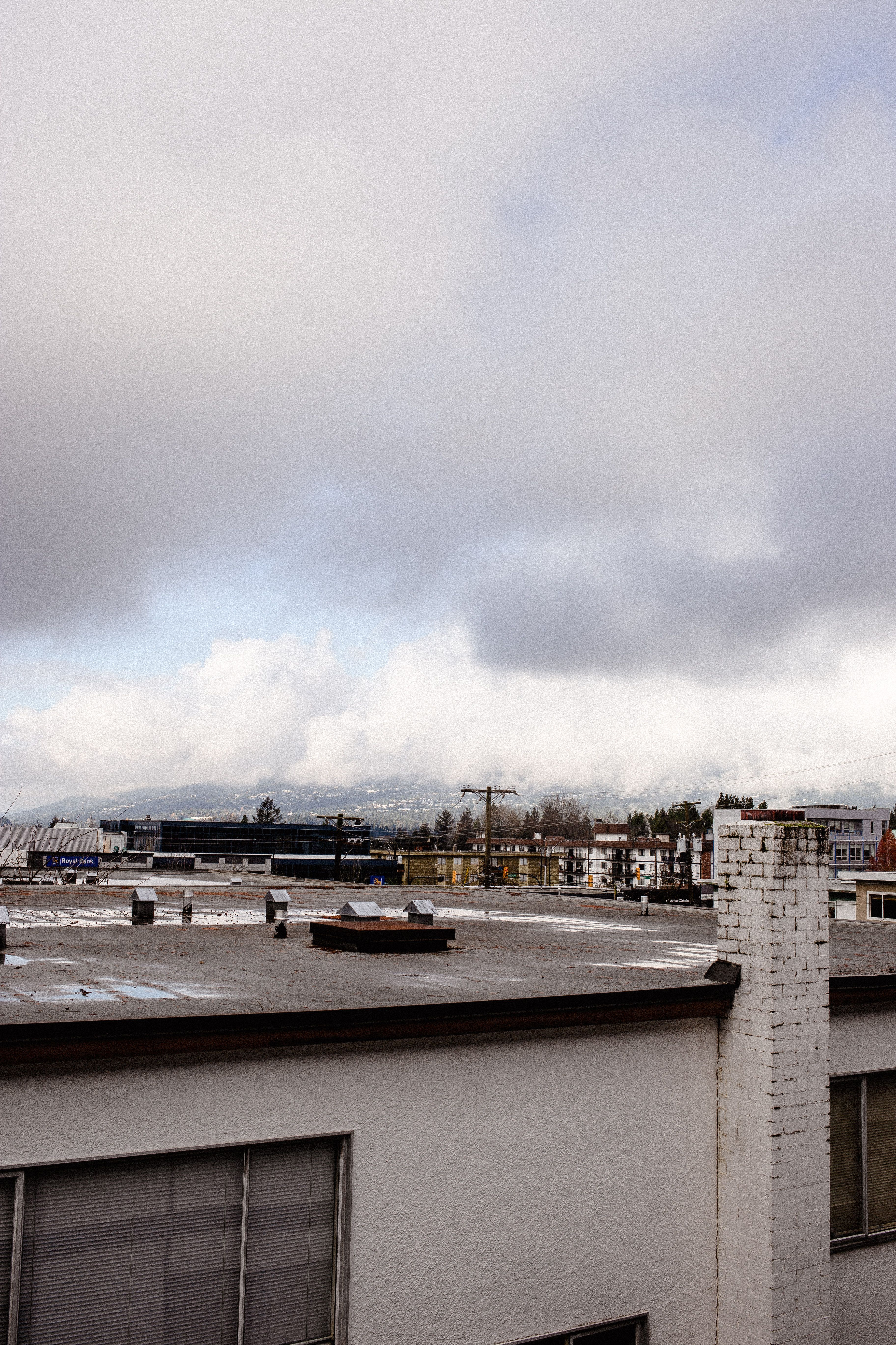 Rooftop of Building Under Gray Cloudy Sky · Free Stock Photo