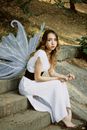Woman Sitting on Stairs with Wings