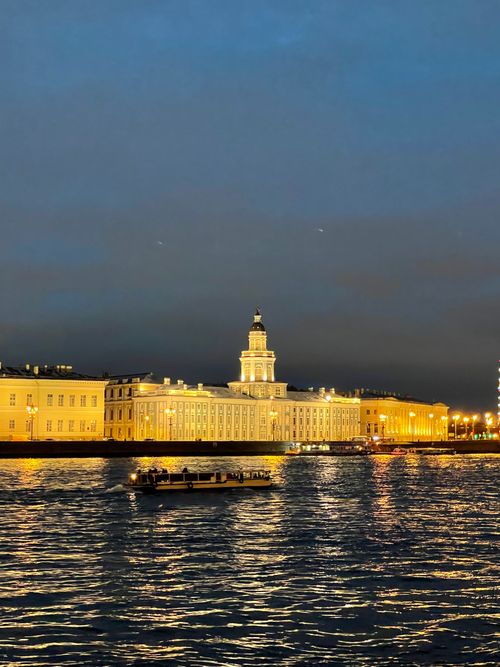 Free Illuminated Kunstkamera building along the Neva River during evening twilight in Saint Petersburg, Russia. Stock Photo