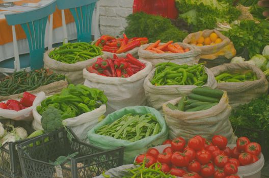 Colorful assortment of vegetables at an outdoor market stall, offering fresh produce in sacks and crates.. pexels, colorful, 