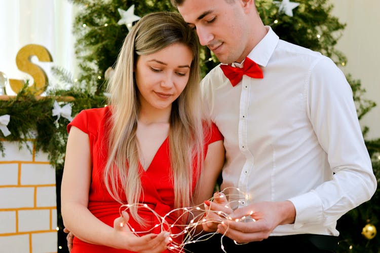 Young Couple With Christmas Lights