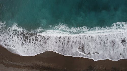 Aerial Photography of Waves Crashing on Beach Shore