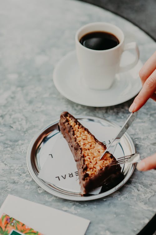 Free Hands of a Person Eating a Slice of Pie Stock Photo