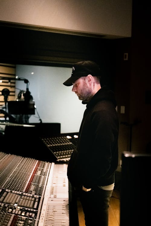 Man Standing Near the Recording Studio Equipment
