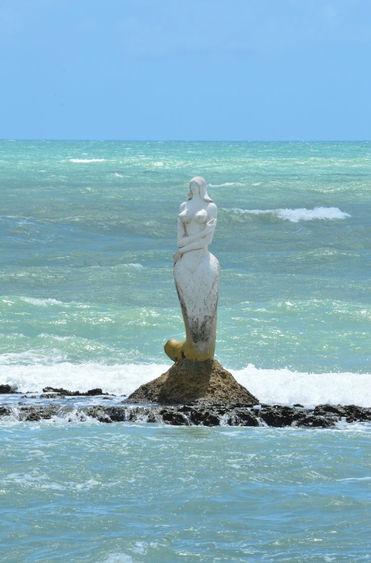 Photo Of A Mermaid Sculpture In The Middle Of The Ocean