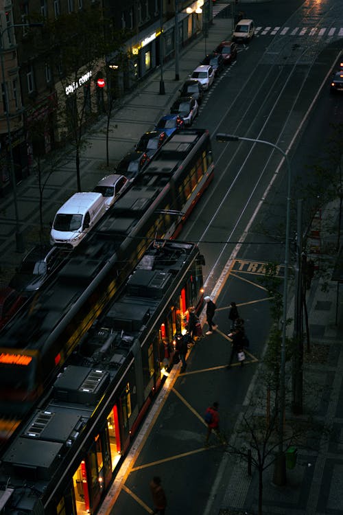 People Riding Tram in the City Street