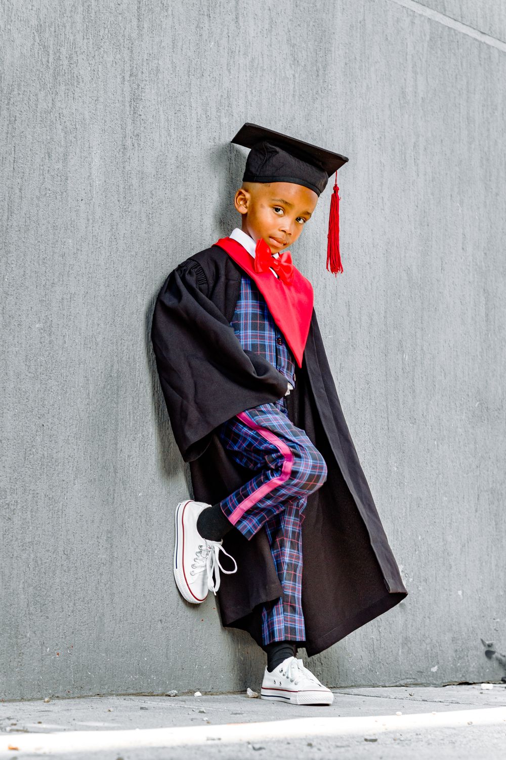 Boy in Black Graduation Gown and Square Academic Cap Leaning on Gray ...