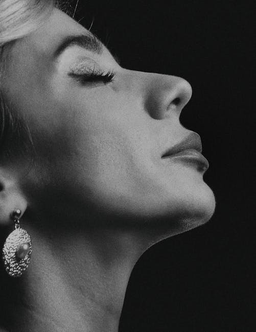 Elegant black and white side profile portrait of a woman with earring