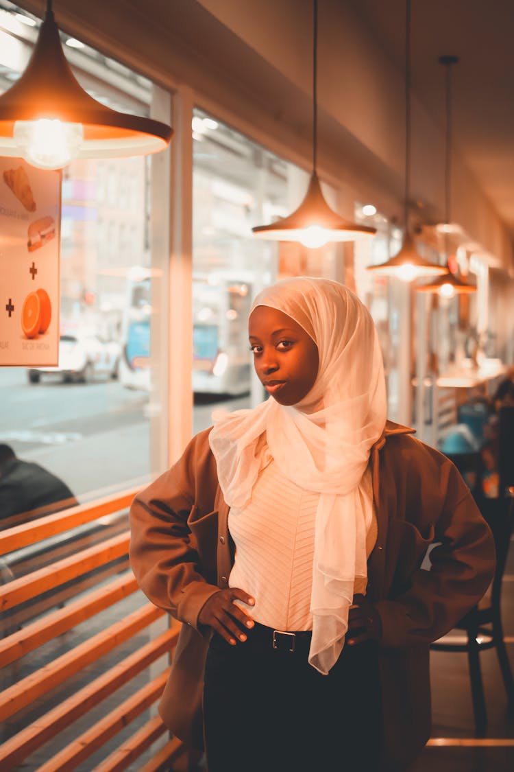 Girl Wearing White Scarf Posing In A Cafe