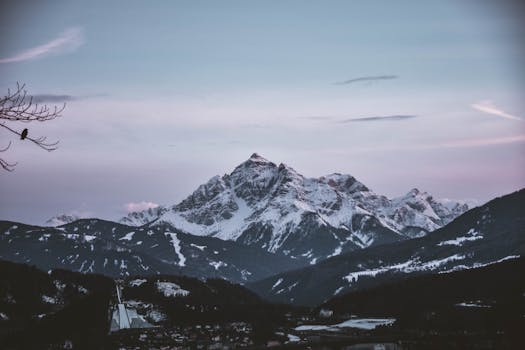 Majestic snow-capped mountains in Innsbruck, Austria, captured during winter twilight.