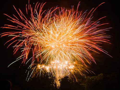 Red and Orange Fireworks in the Dark Sky