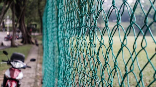 Free Green Cyclone Chain Fence Stock Photo