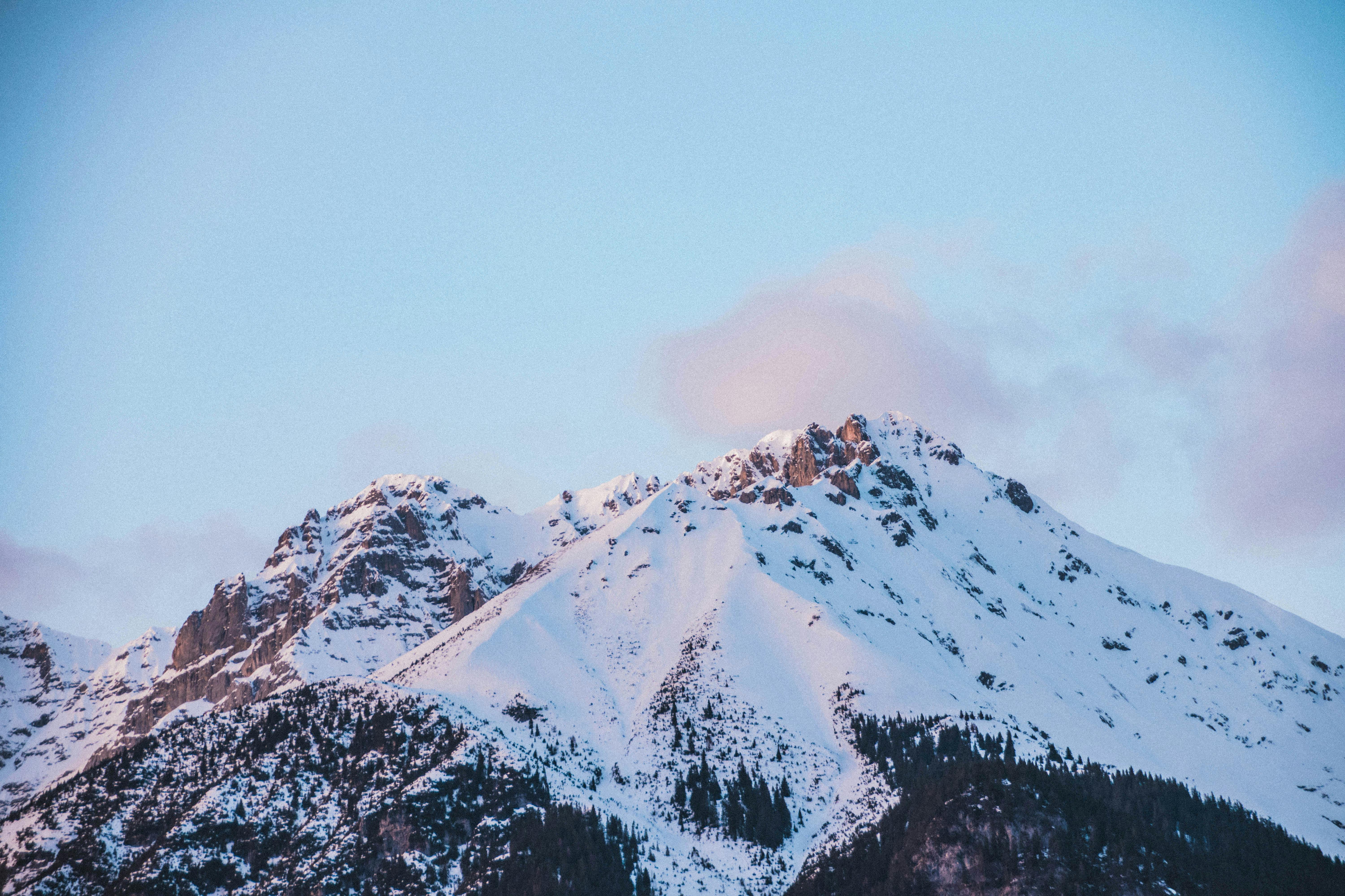Snow Capped Mountains Under the Cloudy Skies · Free Stock Photo