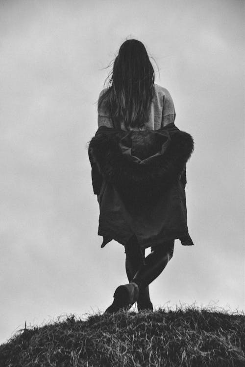 Grayscale Photography of a Woman With Her Legs Cross