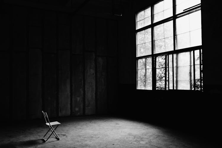 Chair In An Empty Room With Windows