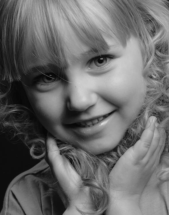 Grayscale Photo of Smiling Girl