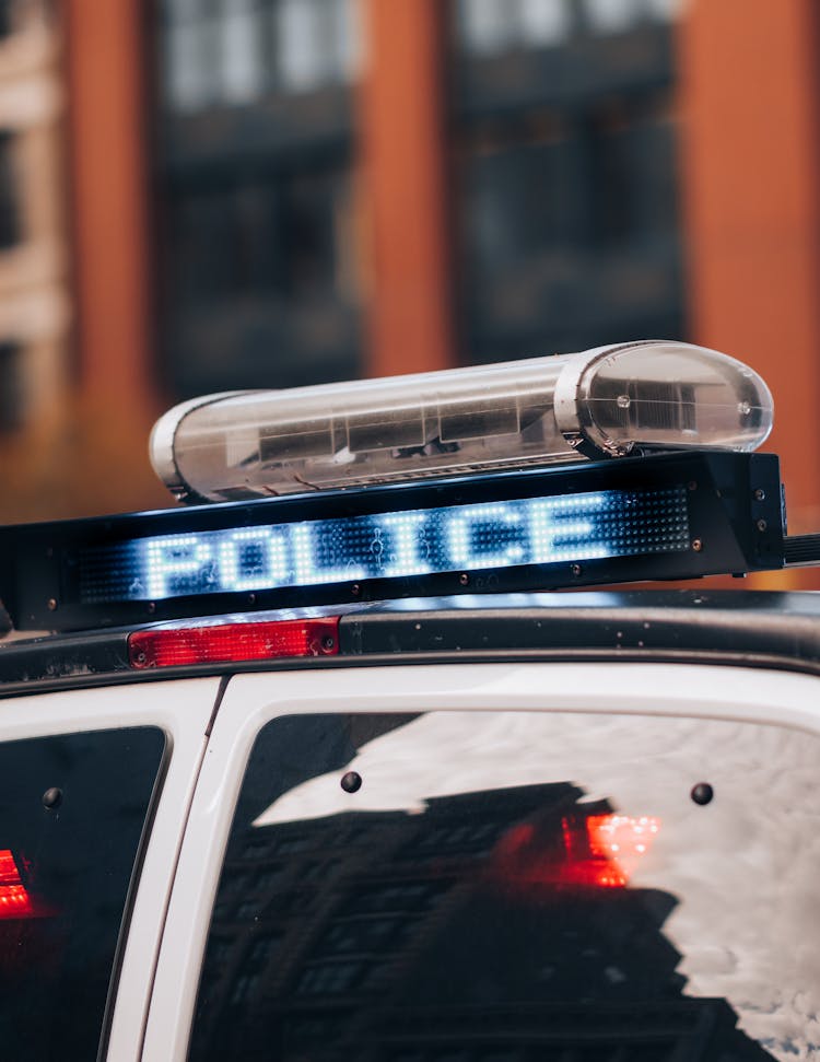 Close-up Of Police Car Roof And Sign