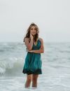 A Portrait of Female Wading in Water and Wearing Wet Dress