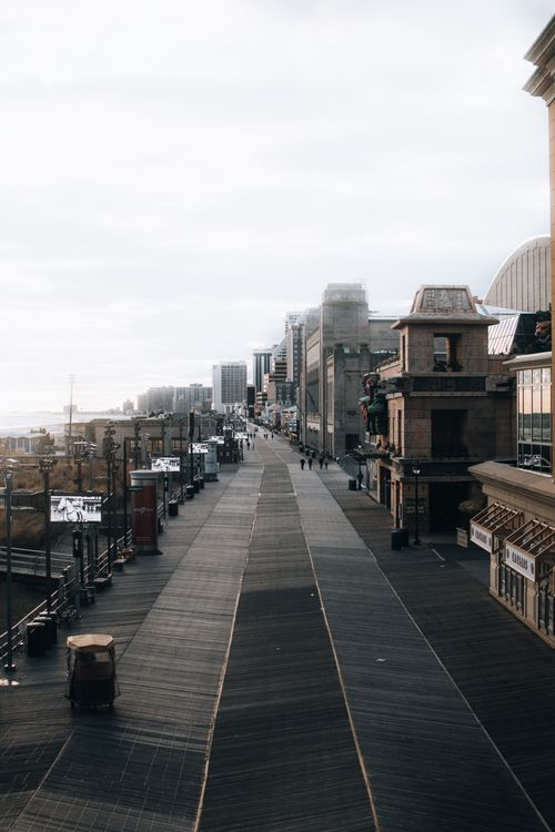 Free A coastal city boardwalk with skyline. Calm, urban landscape during the day. Stock Photo