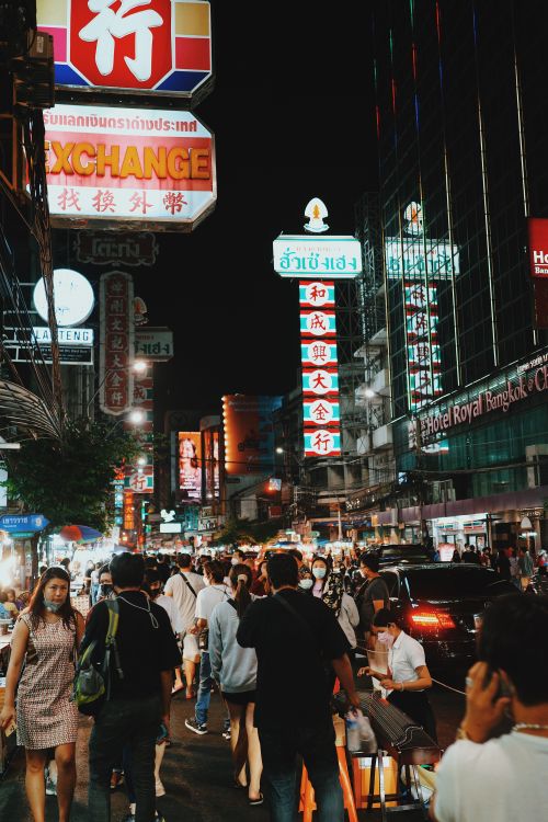 Free Crowded street in Bangkok at night with bright neon signs and energetic nightlife. Stock Photo
