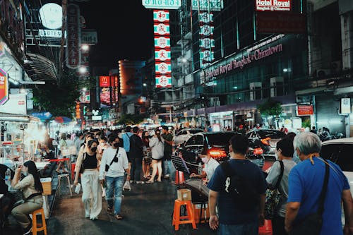 Free People Wearing Facemask Walking on Street during Night Time Stock Photo