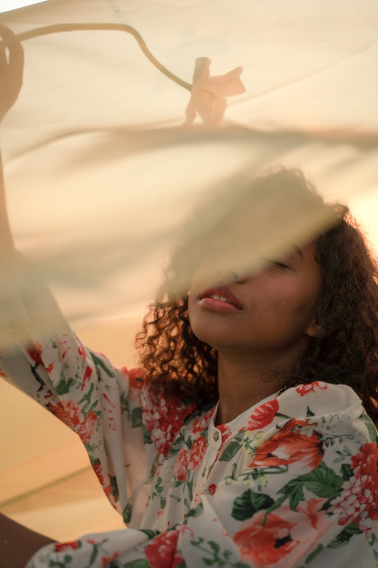 Portrait Of Woman Holding Flower Under See-Through Fabric