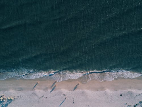 Gray Sand Near Body of Water