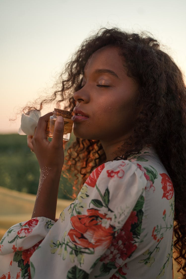 Woman Enjoying Beautiful Smell Of Perfume 