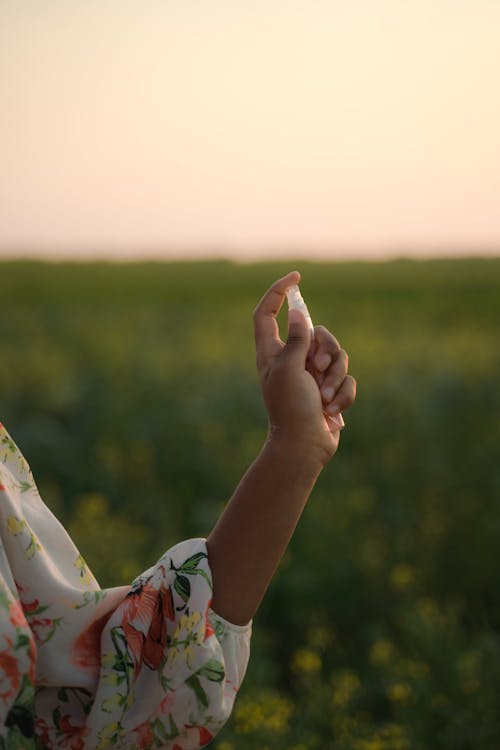 Unrecognizable Female Hand Holding Tiny Perfume Spray Container