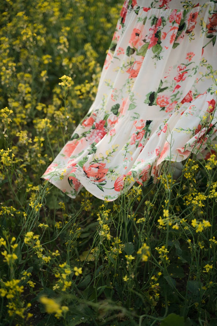 Fragment Of Female Floral Dress Worn By Unrecognizable Person In Flower Field