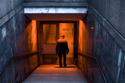 Free A solitary man enters a dimly lit urban subway in Saint Petersburg, Russia. Stock Photo