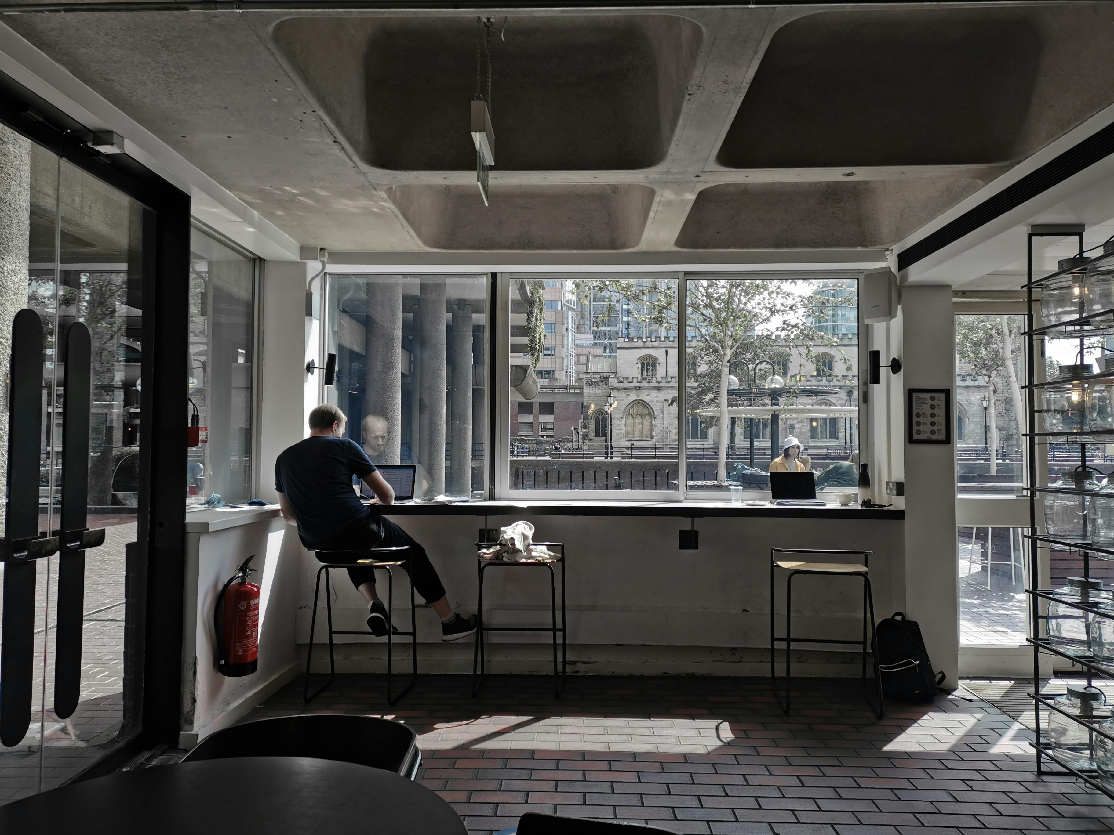 Photo of a Man Working in a Coffee Shop