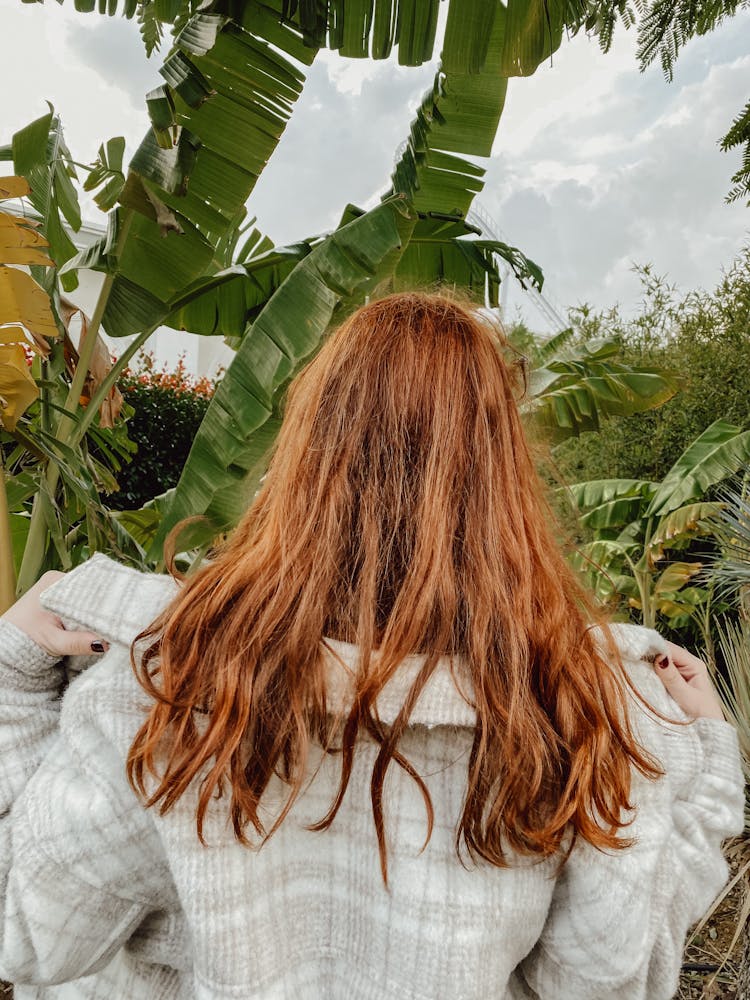 Woman Removing Her Coat Near The BananaTrees