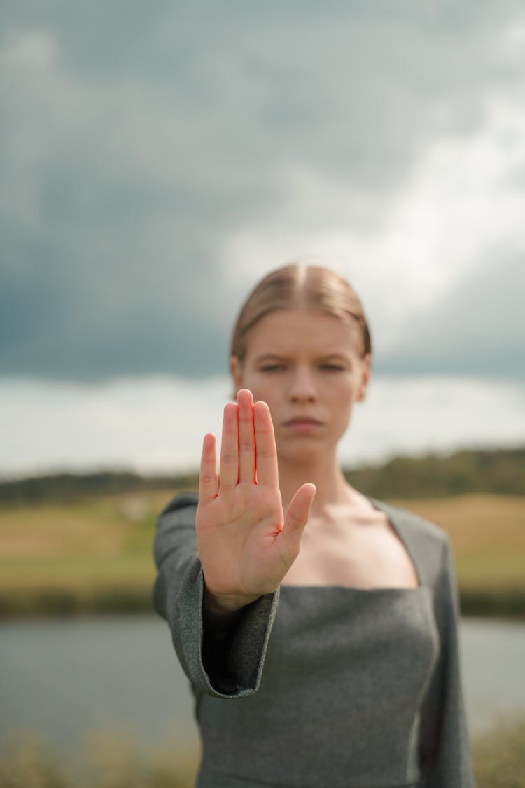 A Woman Doing A Stop Hand Gesture