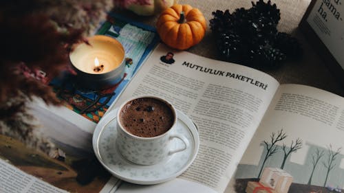 Free A Cup of Hot Chocolate Near a Lit Candle Stock Photo