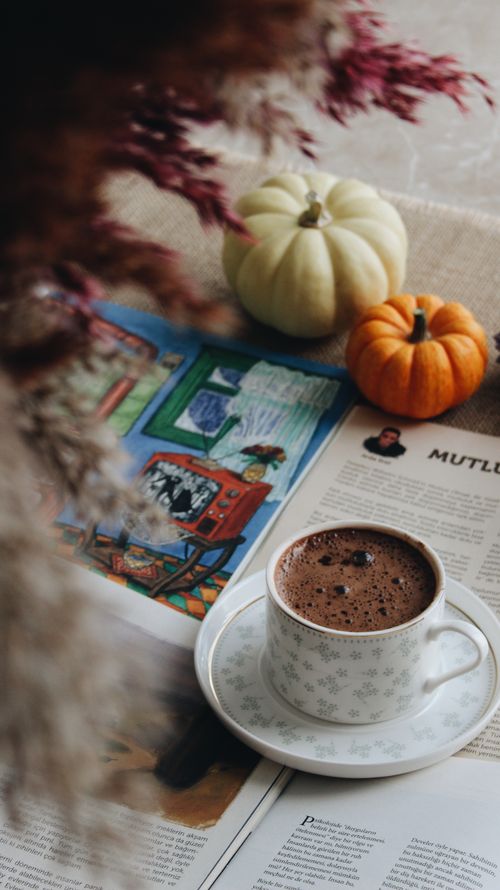 Free Warm autumn scene with a cup of coffee, pumpkins, and a magazine for a cozy feel. Stock Photo