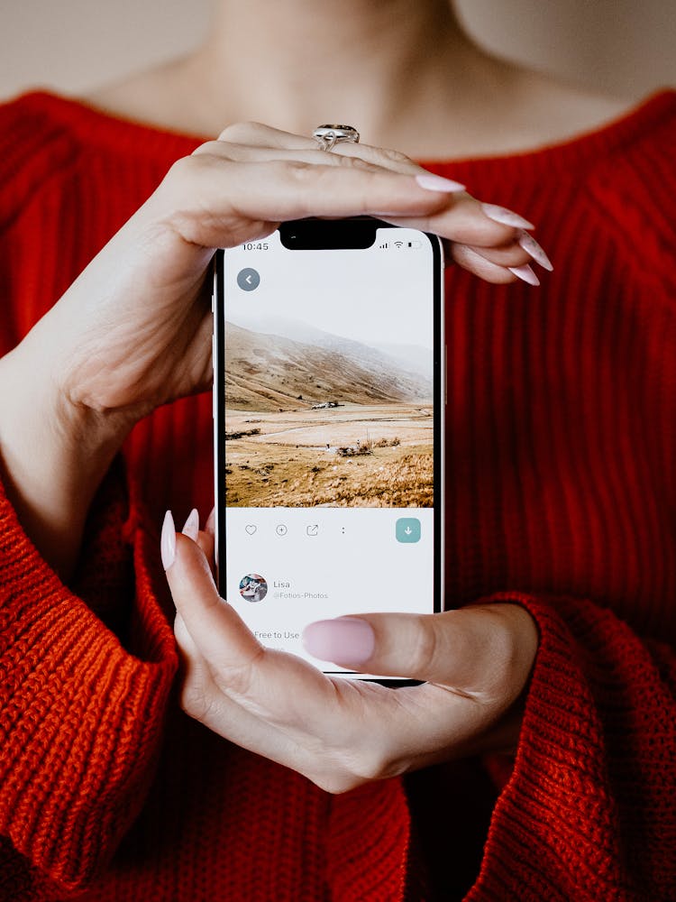 A Shot Of Female Hands Holding A Smart Phone Showing Photo