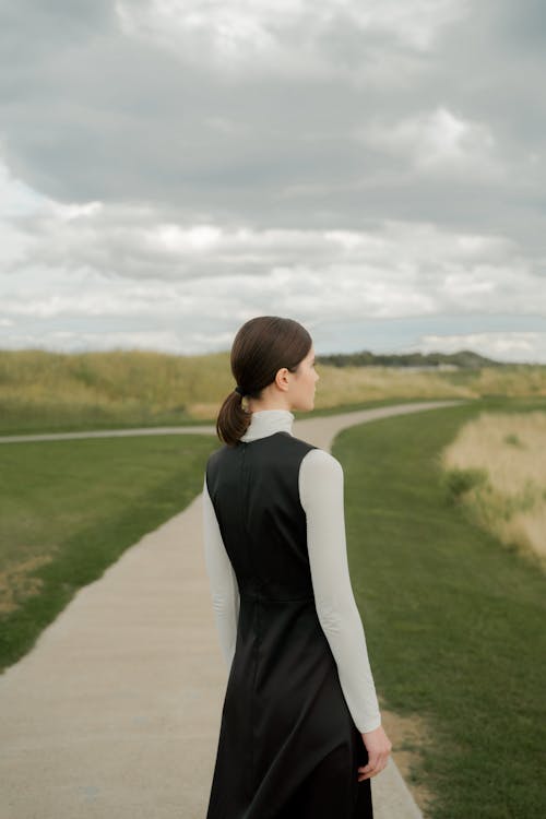 Free Back View of a Woman Wearing Black and White Clothes Stock Photo