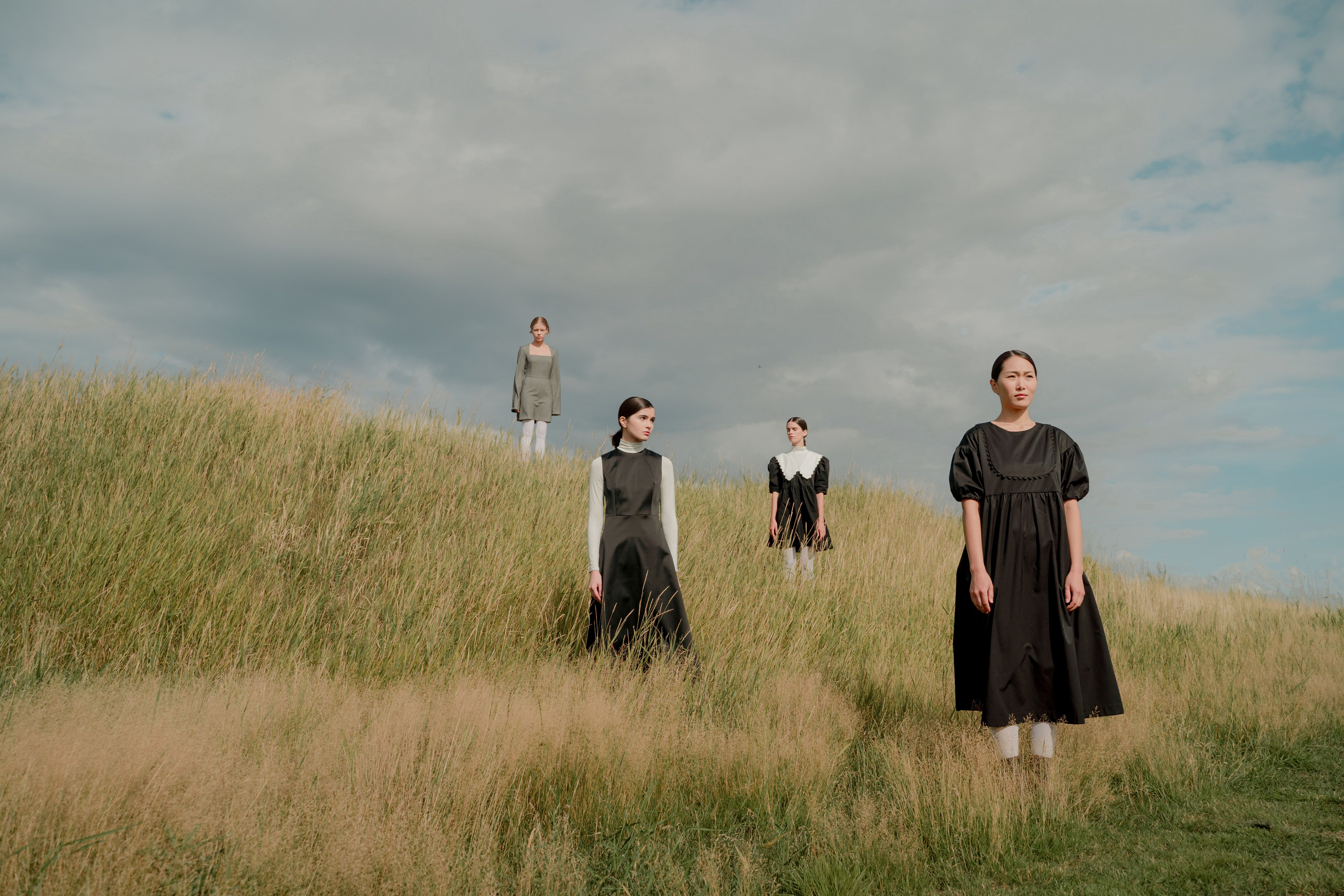 Women in Old-fashioned Dresses Standing in Meadow  Free Stock Photo