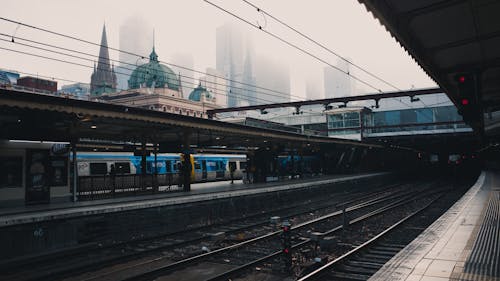 Стоковая Фотография голубого и белого поезда на станции.