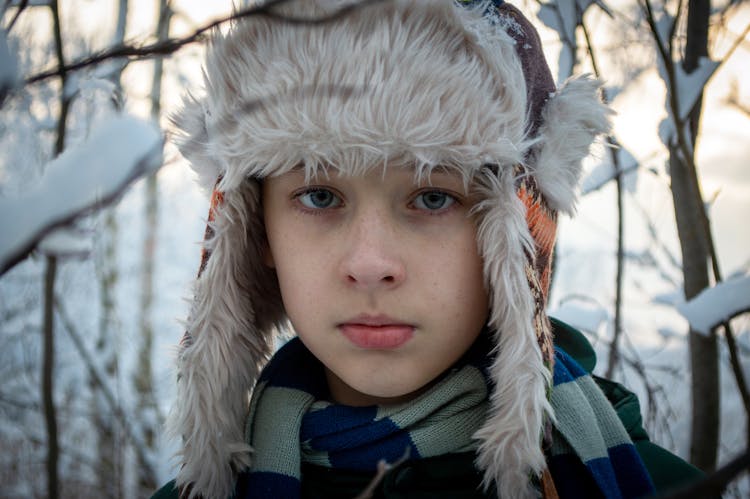 A Child Wearing A Trapper Hat