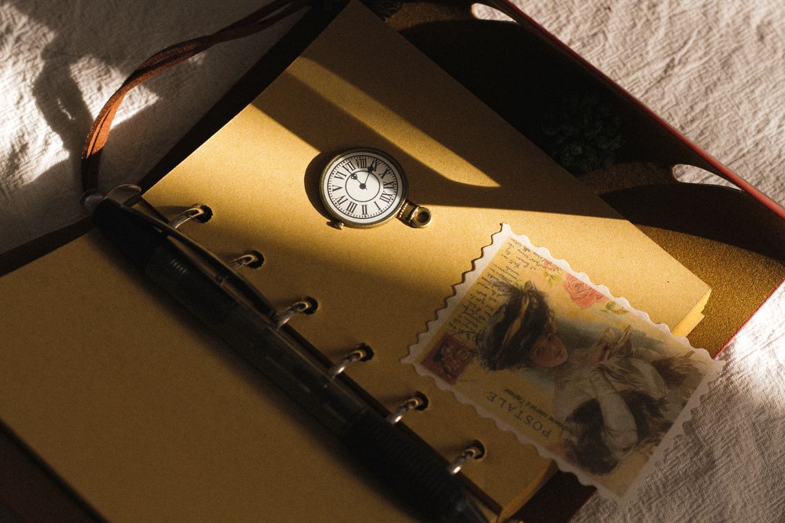Notebook Watcher Pocket Watch on Notebook · Free Stock Photo