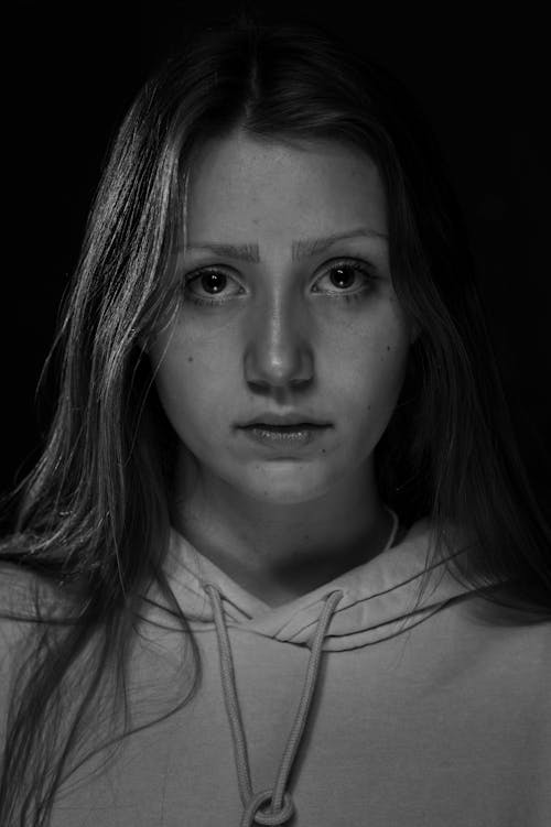 Grayscale Portrait of a Woman in a Hoodie