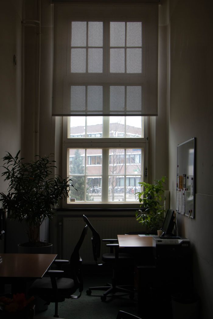Quiet studio room with desks, chairs and plants — photo by Emma on Pexels