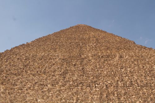 Free Detailed view of the Great Pyramid of Giza with a clear blue sky backdrop, showcasing its stone architecture. Stock Photo